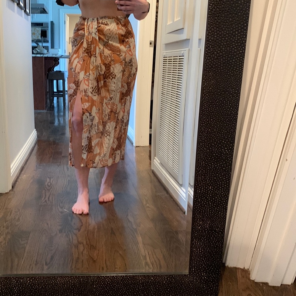 Mid length skirt with slit. Zipper back, rust orange and brown tones